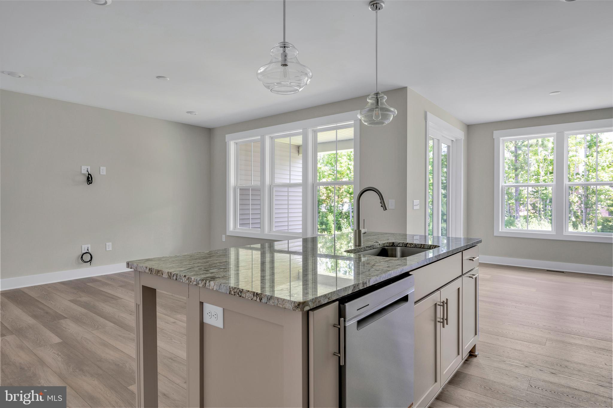 24166 Heartleaf Road Frankford, DE 19945 - Photo 13 of 28 a kitchen with granite countertop a sink and a window