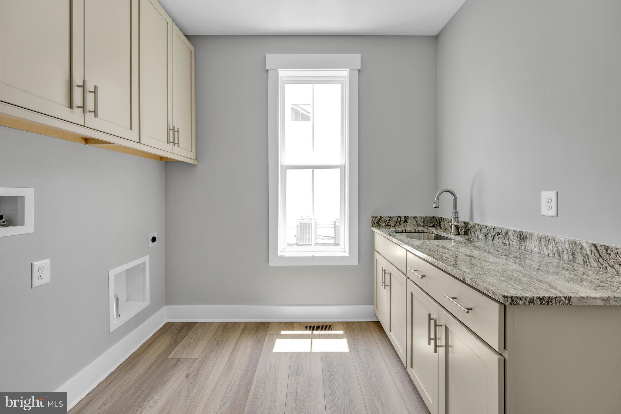 24166 Heartleaf Road Frankford, DE 19945 - Photo 23 of 28 a kitchen with granite countertop a sink stove and cabinets