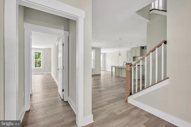 a view of a hallway view with wooden floor and staircase