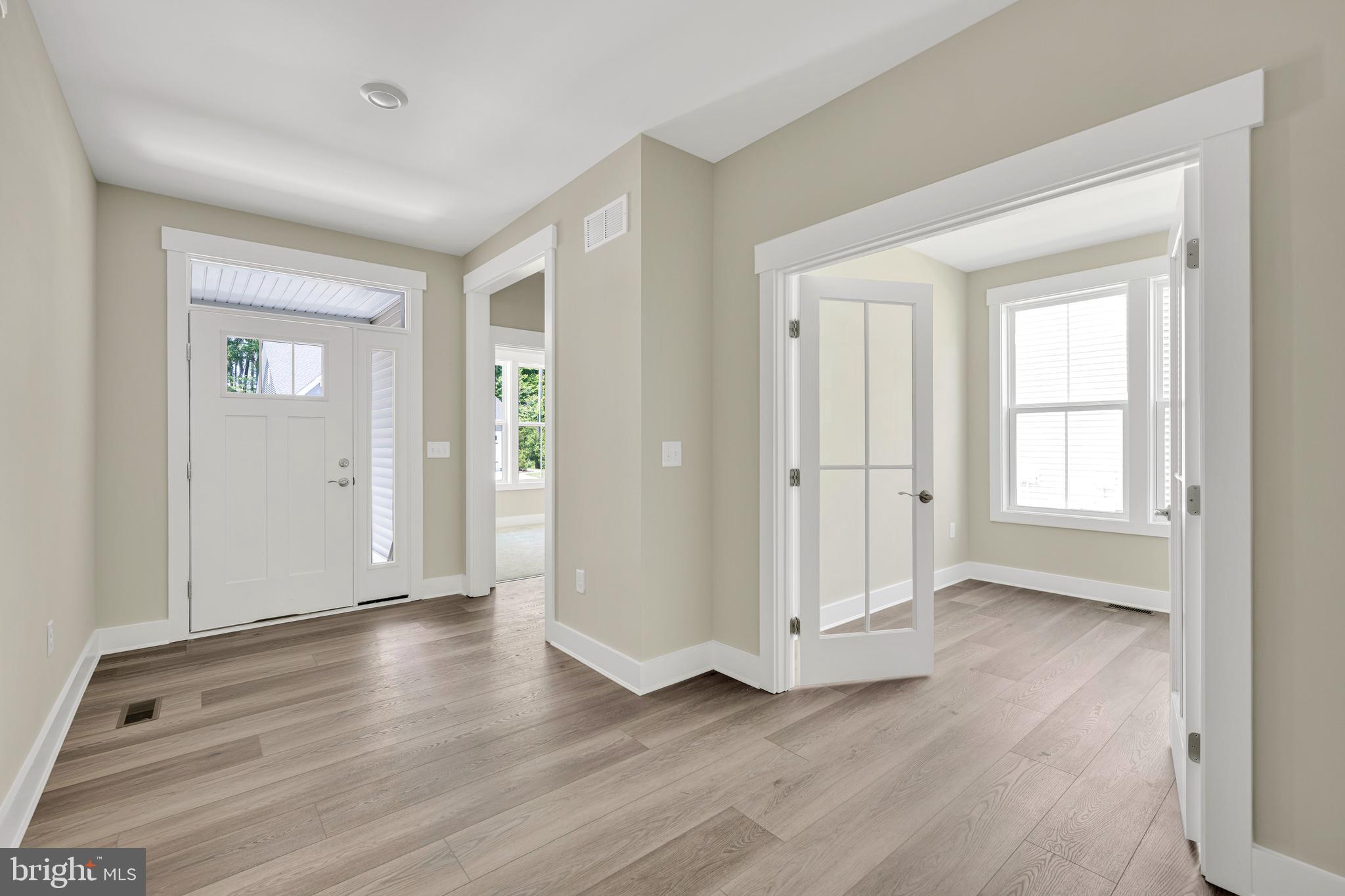 24166 Heartleaf Road Frankford, DE 19945 - Photo 5 of 28 an empty room with wooden floor & windows