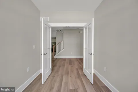 a view of a hallway with wooden floor