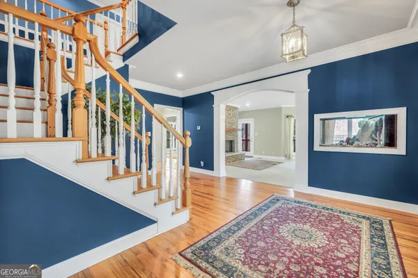 a view of a livingroom with wooden floor and entryway