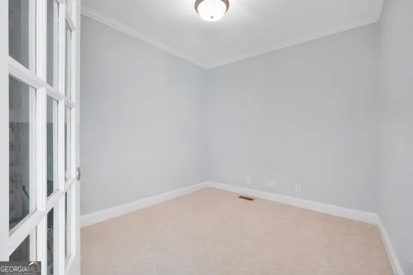 wooden floor to ceiling window and a ceiling fan in a room