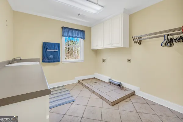 a spacious bathroom with a double vanity sink and mirror