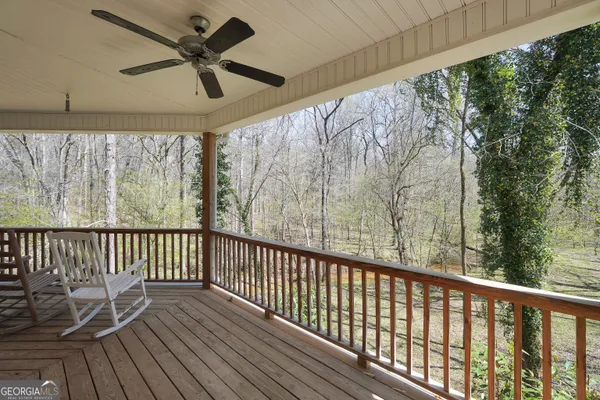 a view of a livingroom with furniture and a ceiling fan