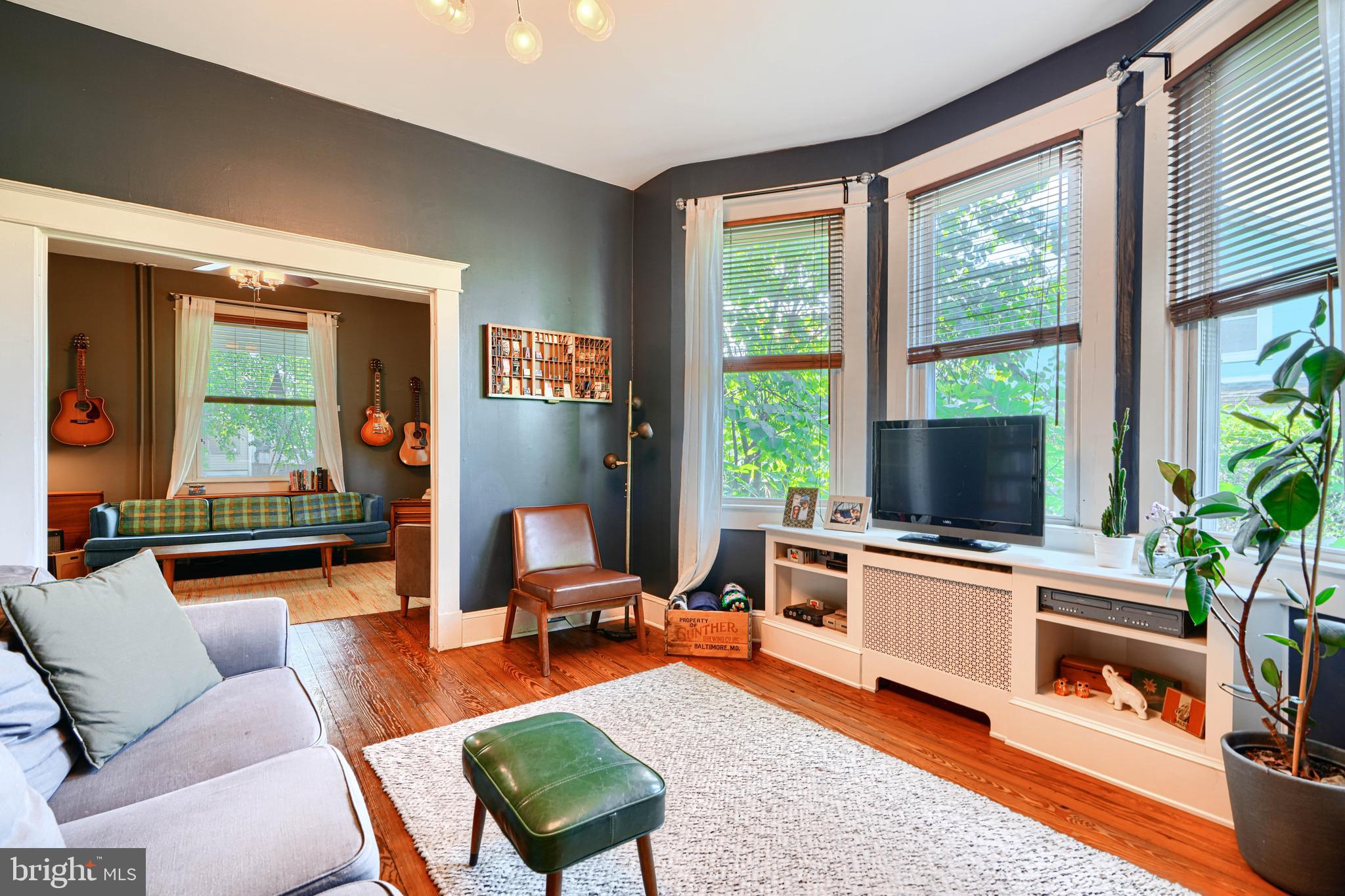 5316 Catalpha Road Baltimore, MD 21214 - Photo 12 of 54 a living room with furniture a flat screen tv and a large window