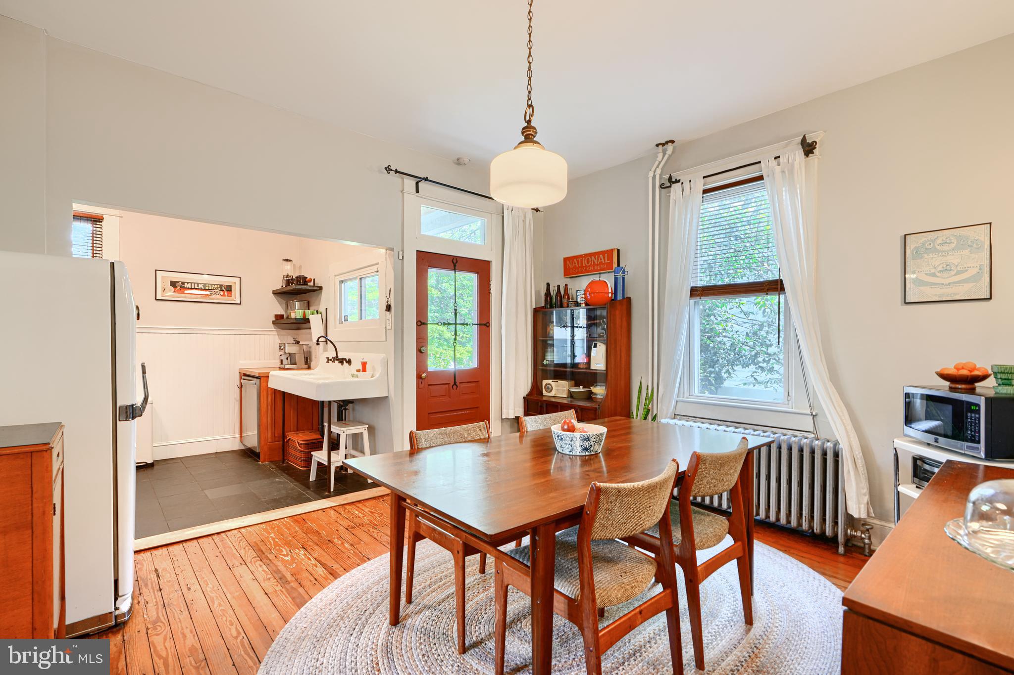 5316 Catalpha Road Baltimore, MD 21214 - Photo 15 of 54 a view of a dining room with furniture window and wooden floor