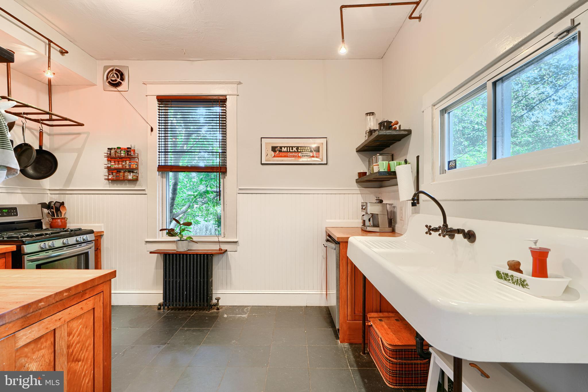 5316 Catalpha Road Baltimore, MD 21214 - Photo 16 of 54 a kitchen with stainless steel appliances a sink a stove and a refrigerator