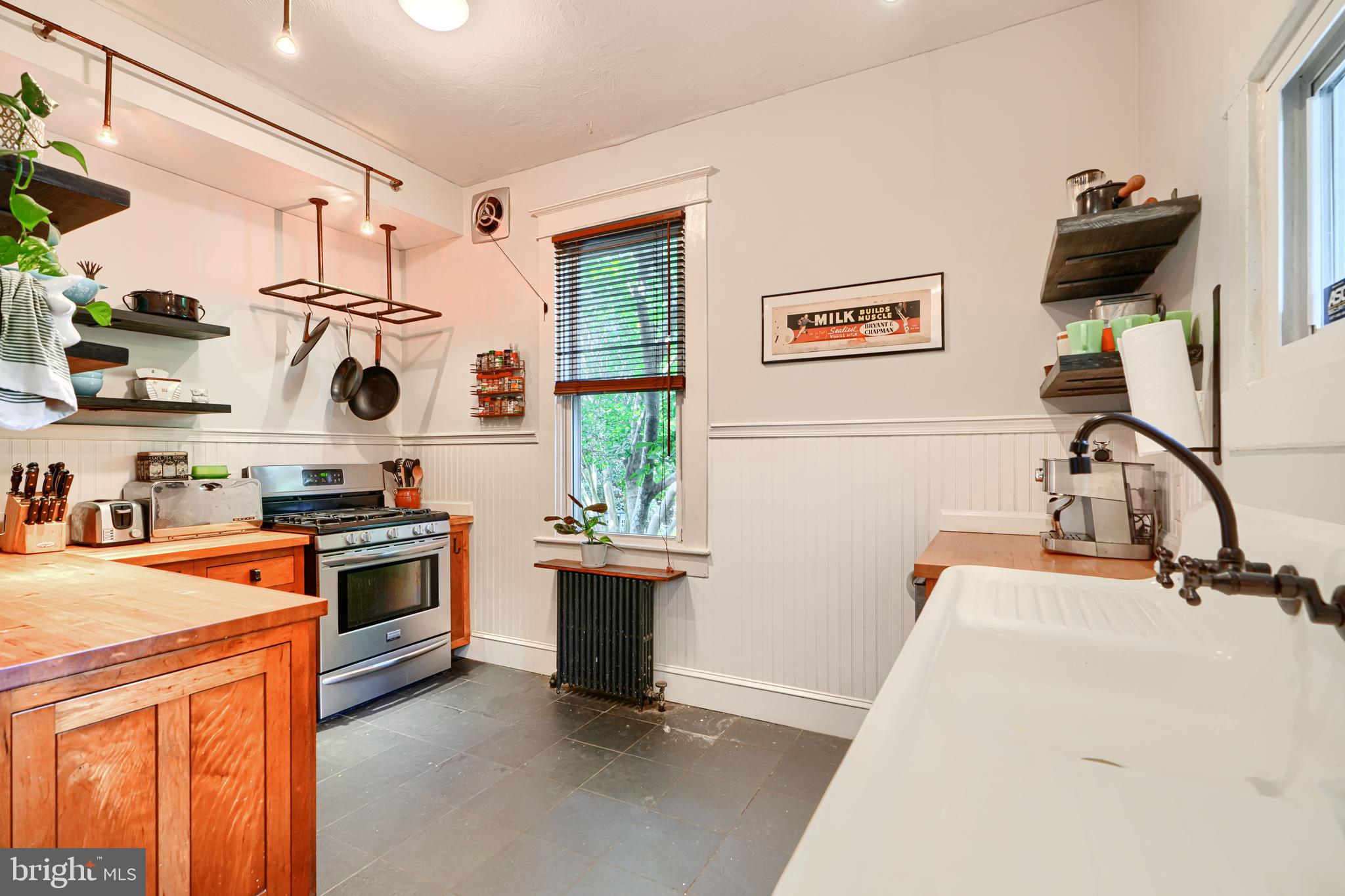 5316 Catalpha Road Baltimore, MD 21214 - Photo 17 of 54 a kitchen with stainless steel appliances granite countertop a sink stove and refrigerator