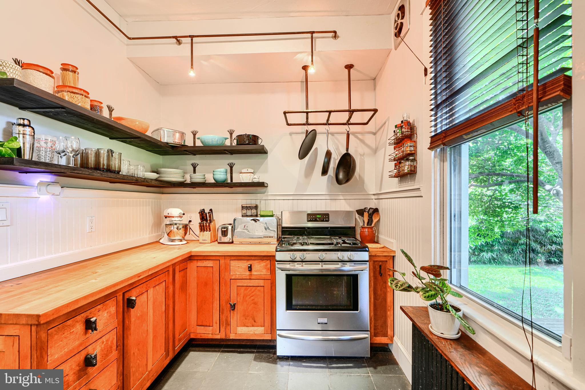 5316 Catalpha Road Baltimore, MD 21214 - Photo 18 of 54 a kitchen with a stove and a white cabinets