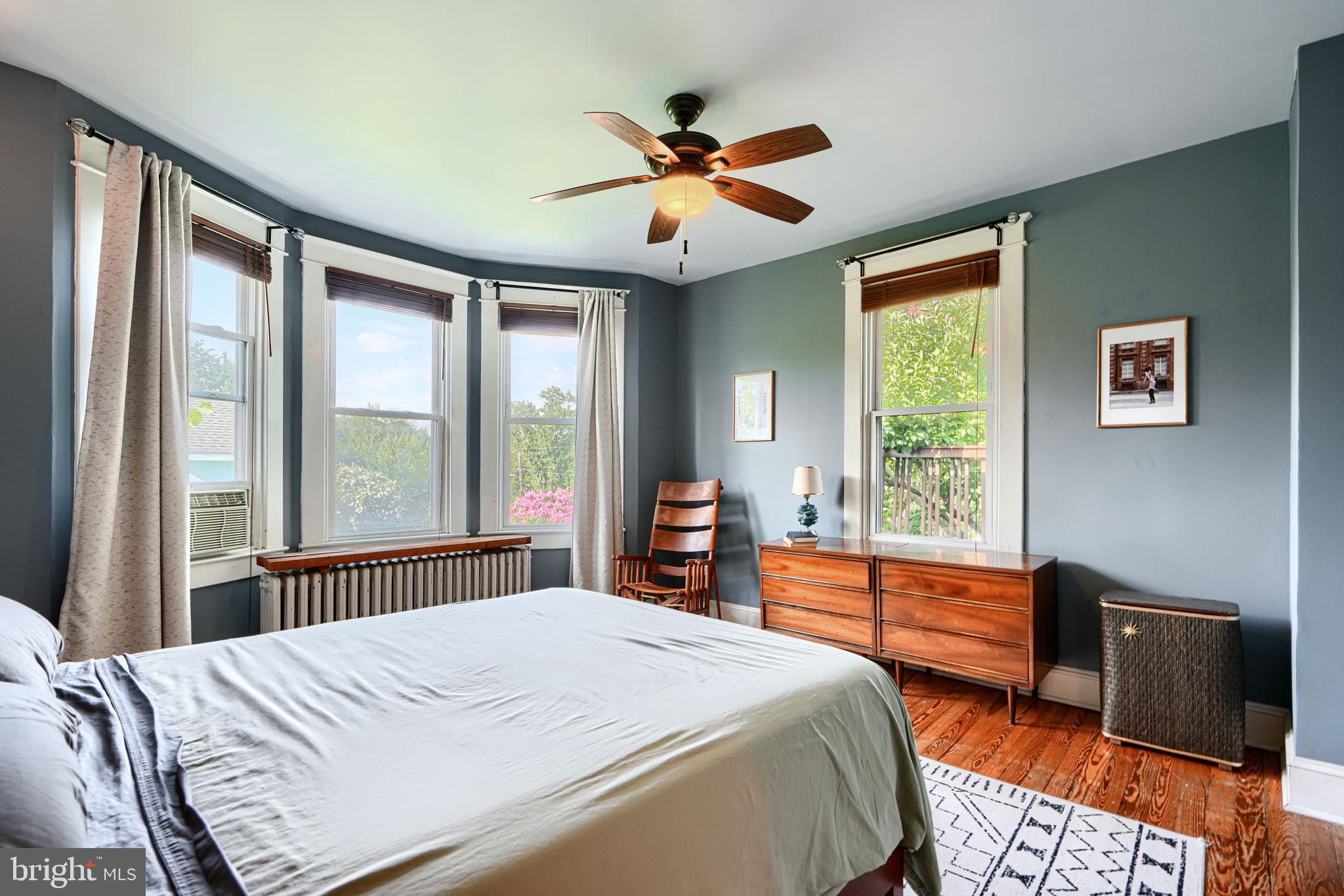 5316 Catalpha Road Baltimore, MD 21214 - Photo 22 of 54 a bedroom with a bed and a large window with chair