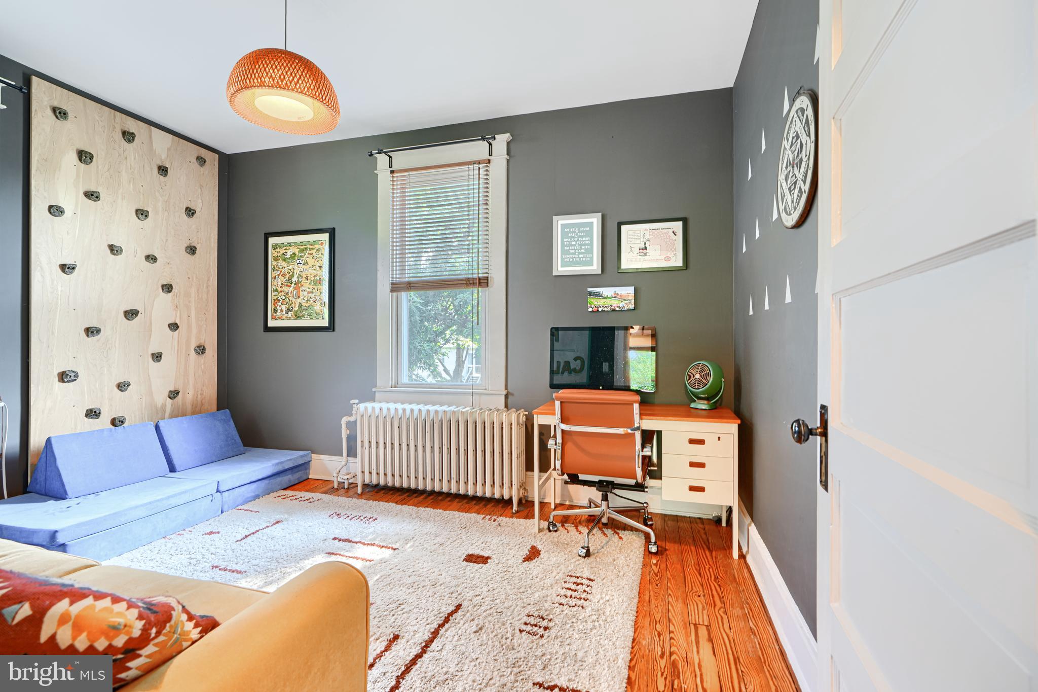 5316 Catalpha Road Baltimore, MD 21214 - Photo 26 of 54 a bedroom with furniture and a wooden floor