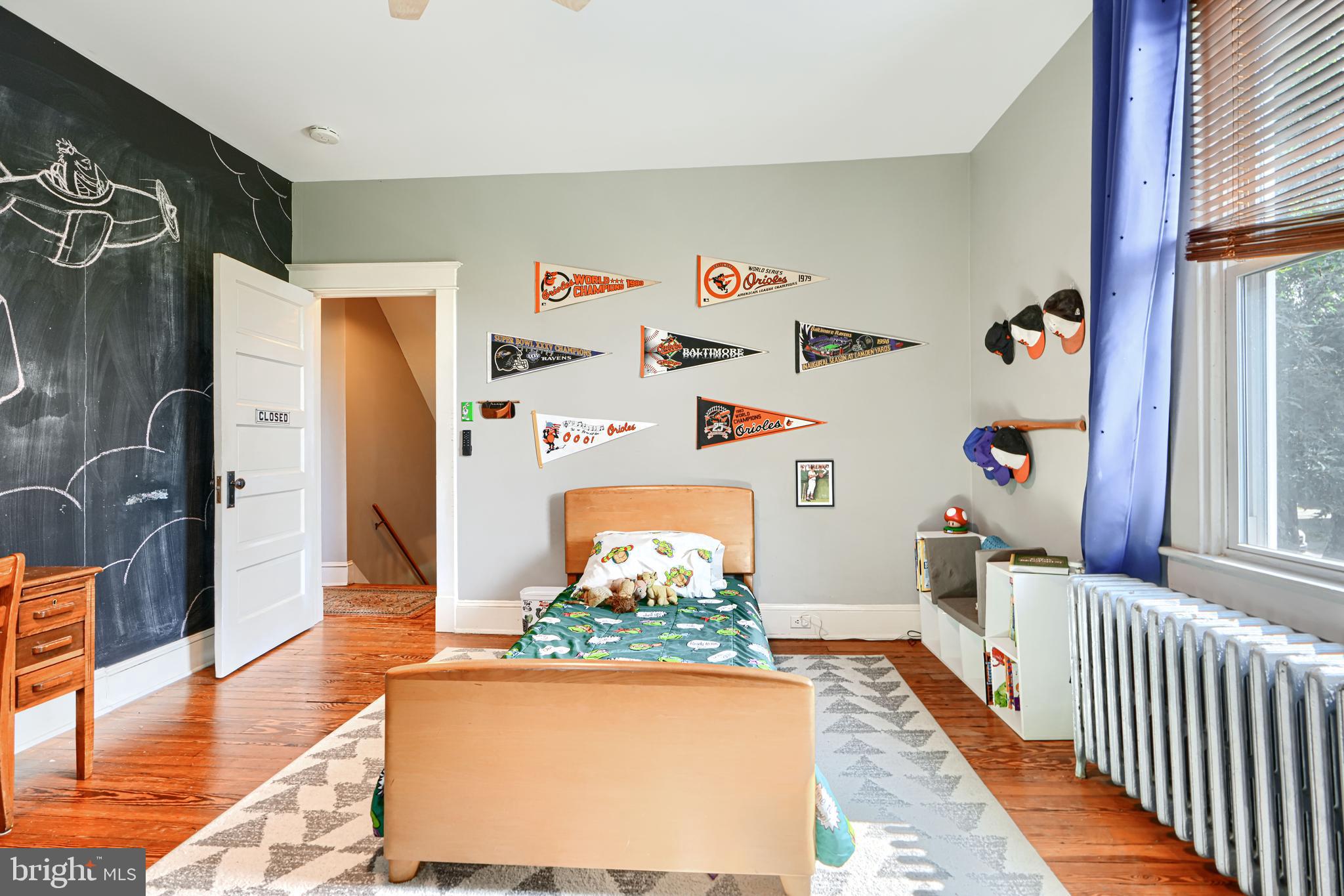 5316 Catalpha Road Baltimore, MD 21214 - Photo 30 of 54 a hallway with dining area and wooden floor