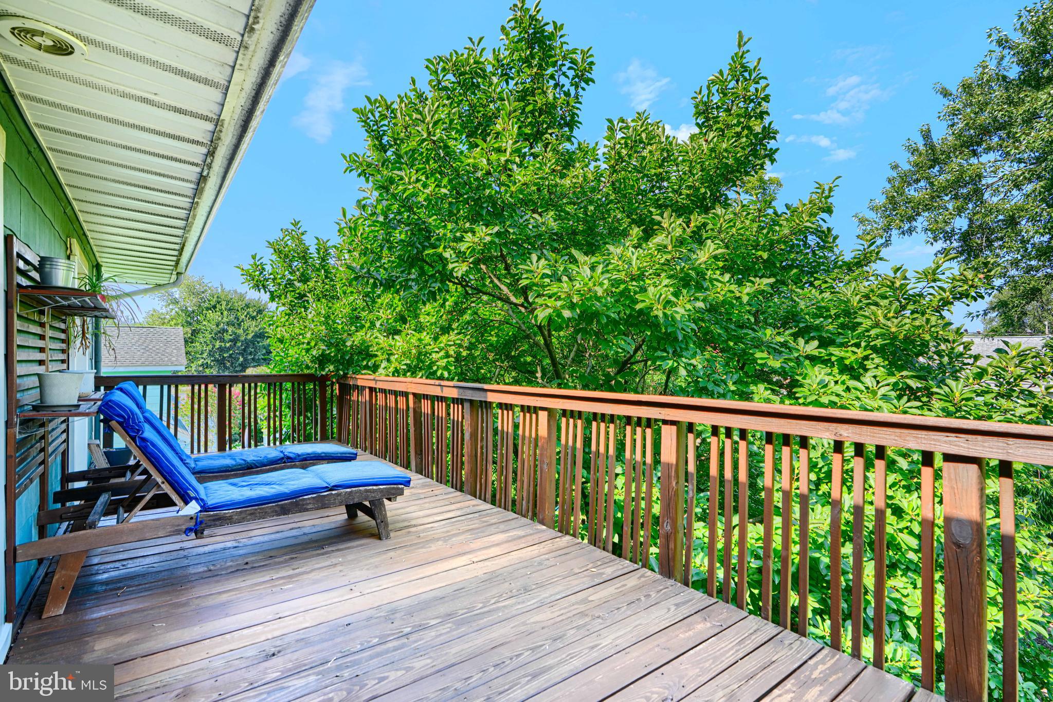 5316 Catalpha Road Baltimore, MD 21214 - Photo 32 of 54 a view of a wooden deck with a bench