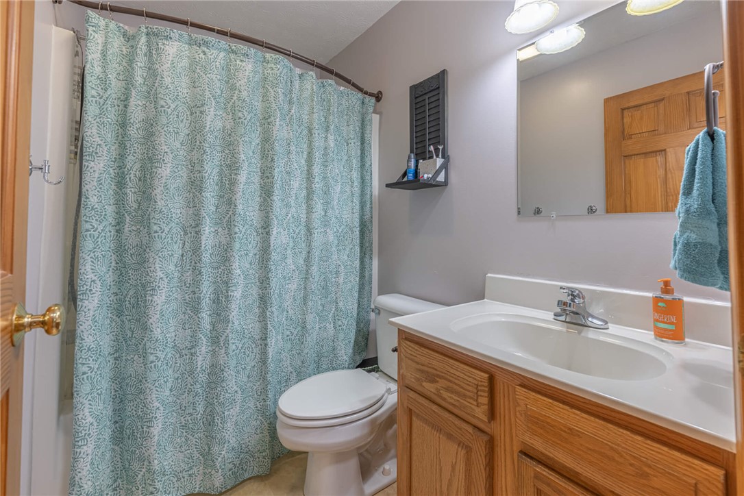 2645 Vance Road St. Paris, OH 43072 - Photo 19 of 35 This full bathroom offers a functional vanity with ample storage and an easy-access shower area.