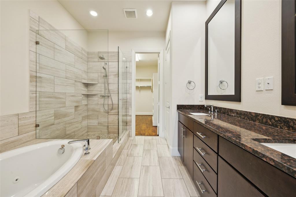 2134 Canton Street Dallas, TX 75201 - Photo 11 of 34 Bathroom with a shower stall, double vanity, a bath, a spacious closet, and recessed lighting