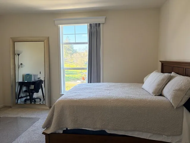a bedroom with a bed and window