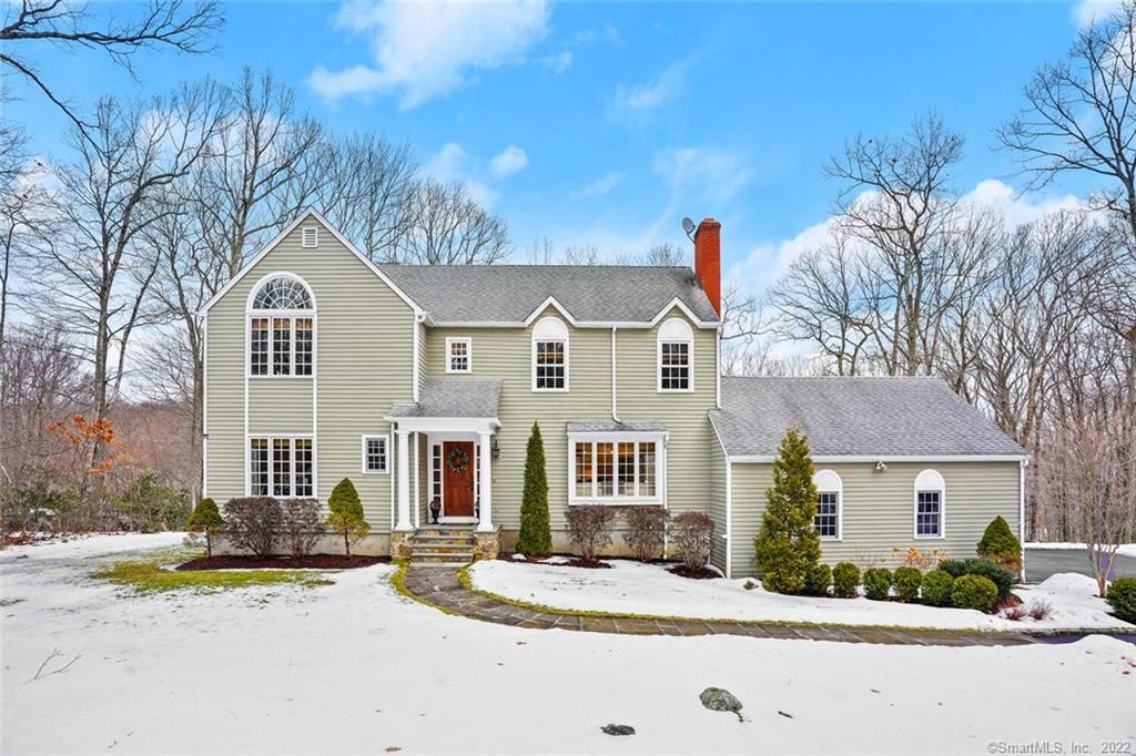9 Middlebrook Pond Road Redding, CT 06896 - Photo 1 of 1 a front view of a house with a yard and garage