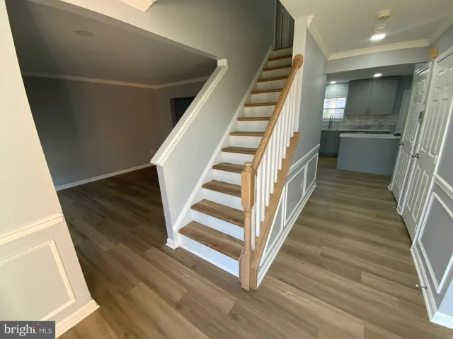 a view of entryway and hall with wooden floor