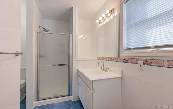 a bathroom with a sink a mirror and a shower