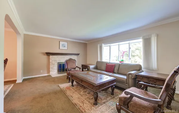 a living room with furniture a fireplace and a table