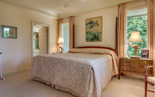 25 Sea Marsh Road Fernandina Beach, FL 32034 - Photo 4 of 24 a bed sitting in a bedroom next to a window