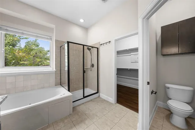 a bathroom with a bathtub toilet and shower