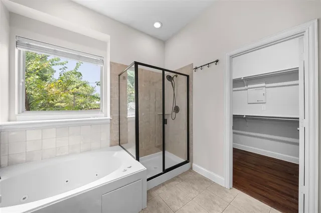 a bathroom with a bathtub and a shower