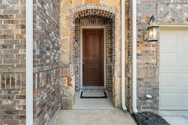 a view of a door with brick walls