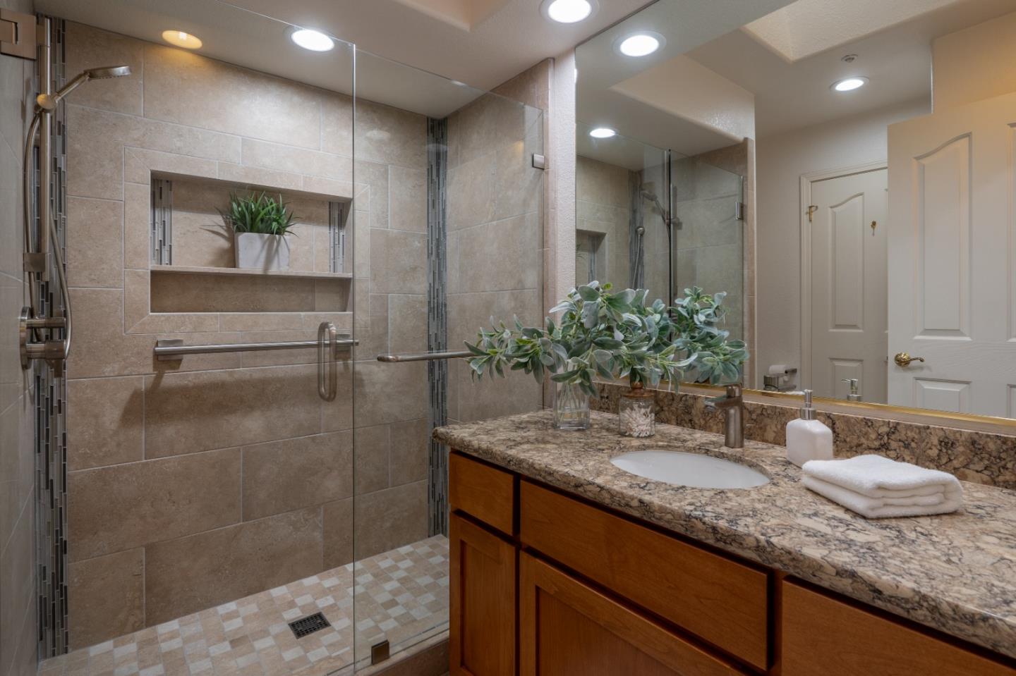 204 Ridge Road Pacific Grove, CA 93950 - Photo 14 of 15 a bathroom with a granite countertop sink a mirror and a shower