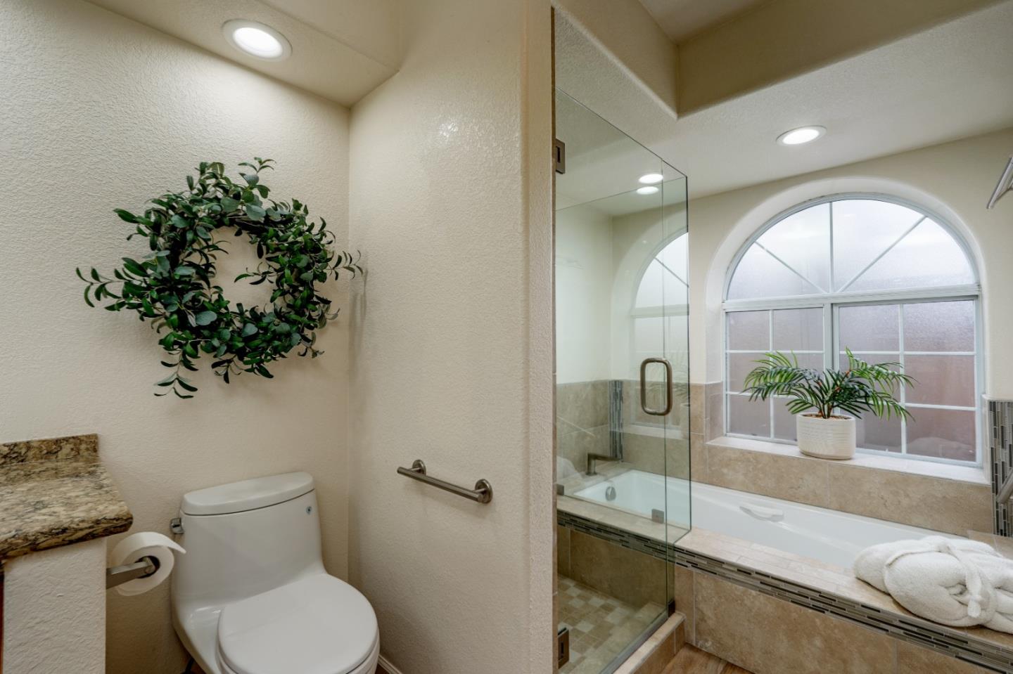 204 Ridge Road Pacific Grove, CA 93950 - Photo 10 of 15 a bathroom with a toilet sink and mirror