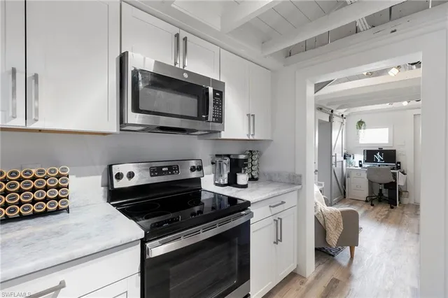 a kitchen with kitchen island a refrigerator sink and cabinets