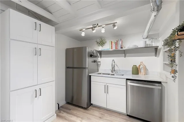 a kitchen with a sink appliances and cabinets