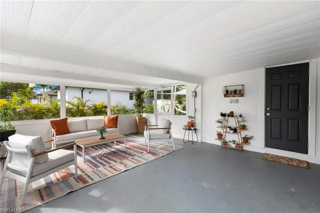 a view of a white house with a patio