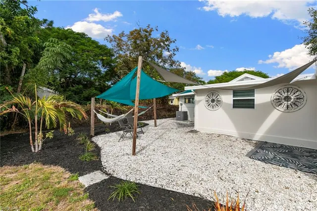 a view of a backyard with sitting area