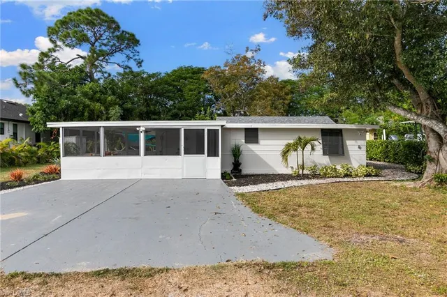 a view of a garden with a building in the background