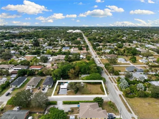 an aerial view of residential houses with city view