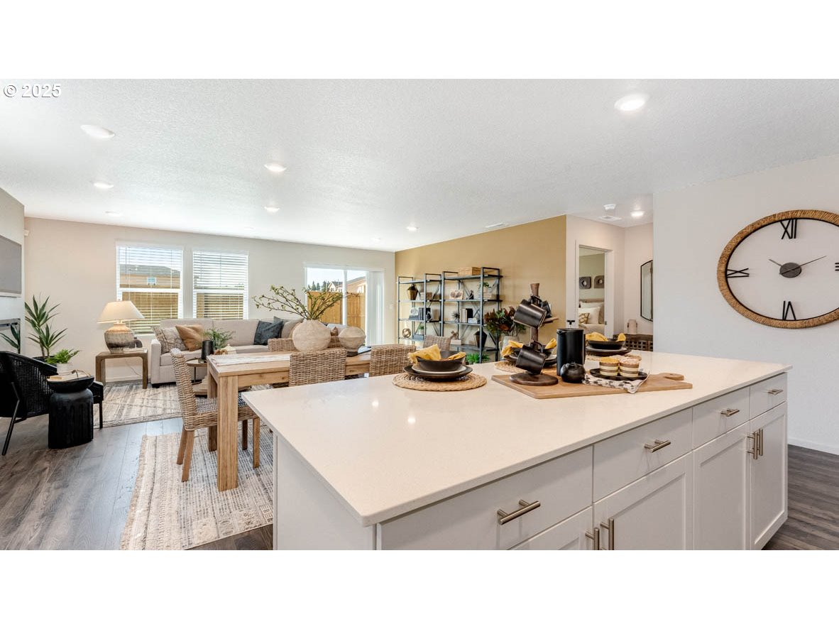 2905 V Street Springfield, OR 97477 - Photo 14 of 27 a kitchen with a sink dishwasher a dining table and chairs with wooden floor