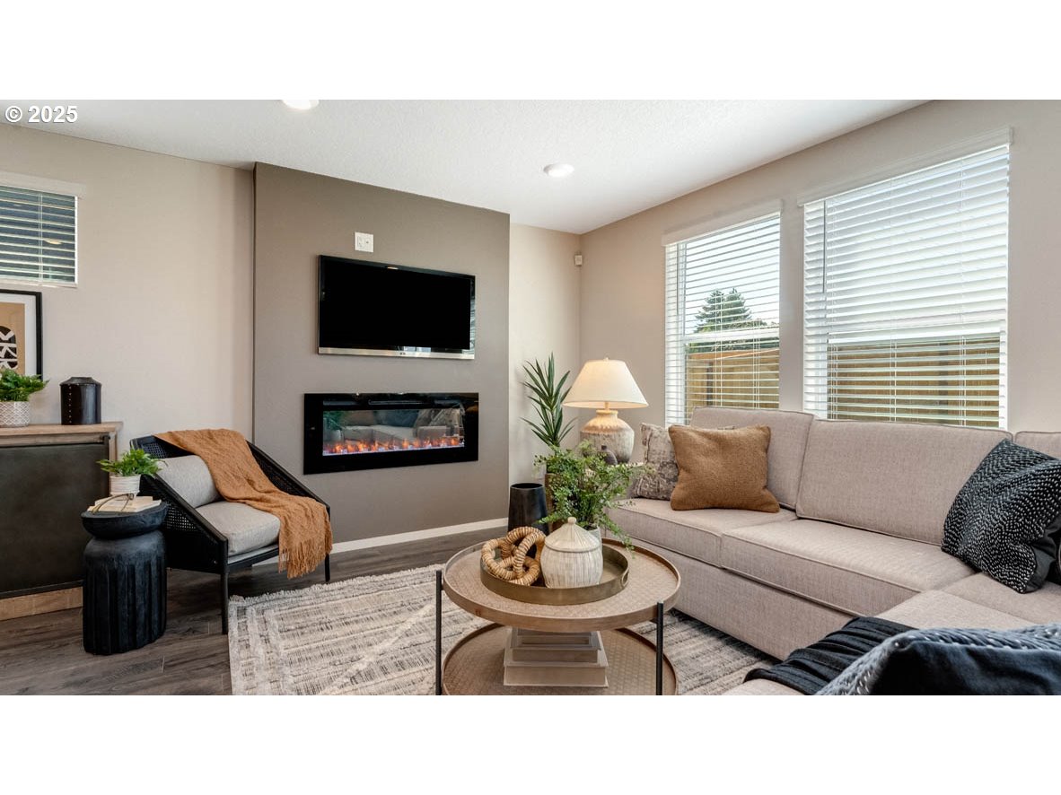 2905 V Street Springfield, OR 97477 - Photo 17 of 27 a living room with furniture a flat screen tv and a fireplace