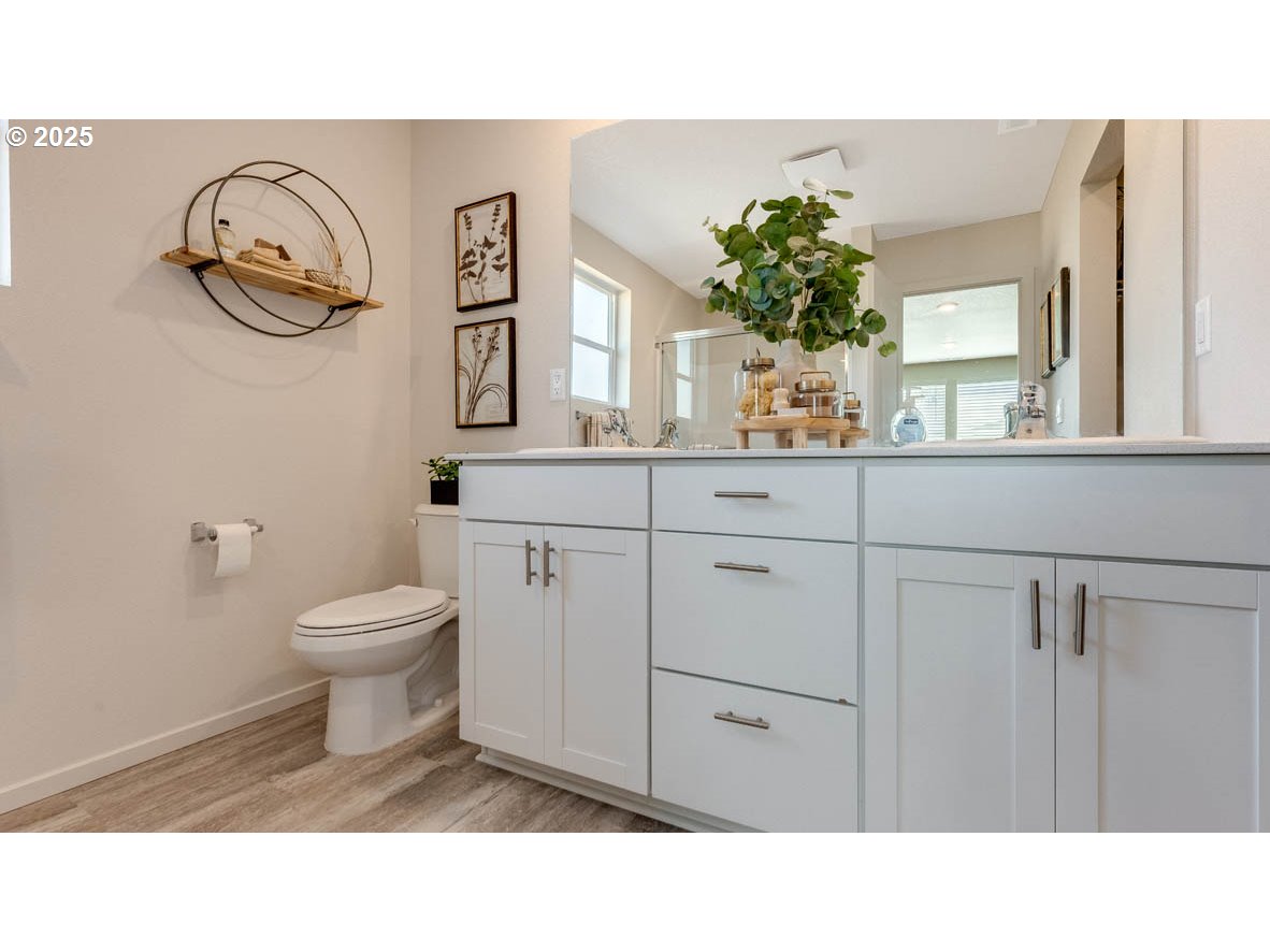 2905 V Street Springfield, OR 97477 - Photo 23 of 27 a bathroom with a toilet a sink and mirror