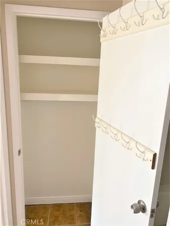 a view of walk in closet with clothes
