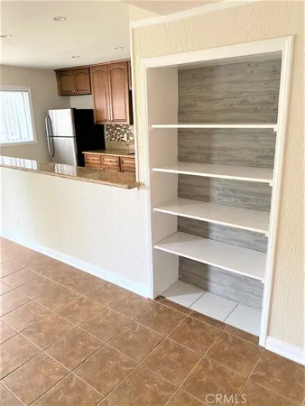 a view of a kitchen with an empty space and wooden floor