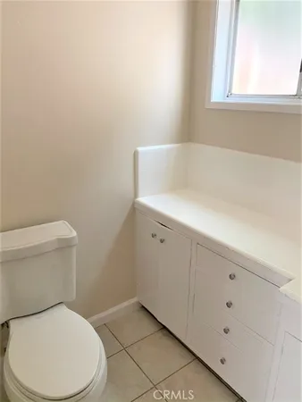 a white toilet sitting next to a window