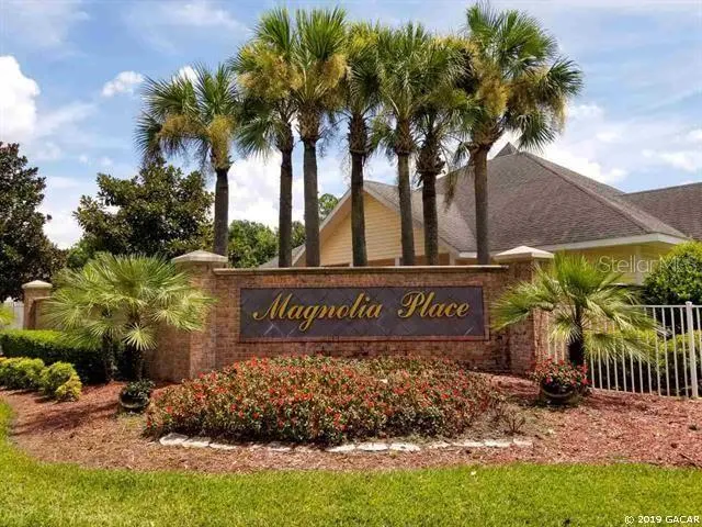 a sign broad in front of the red brick house