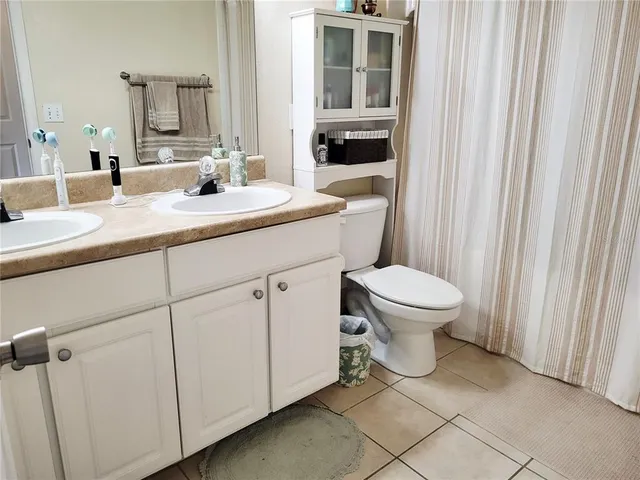 a bedroom with a bed furniture and a flat screen tv