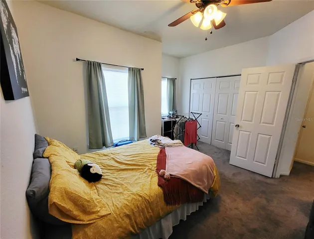 a bedroom with a bed and a mirror