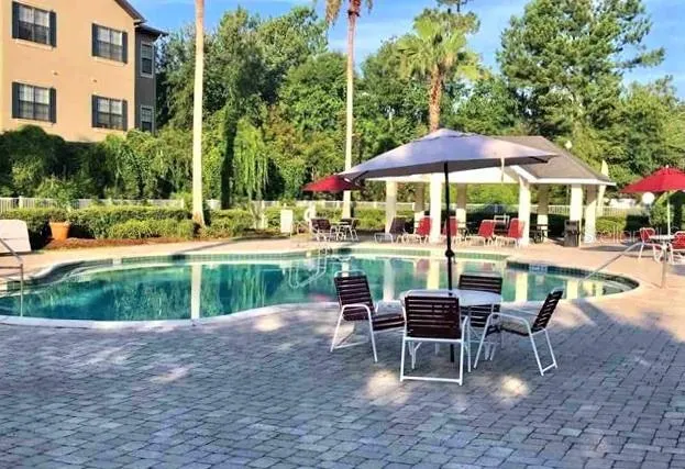 a chair and tables in the patio of a house