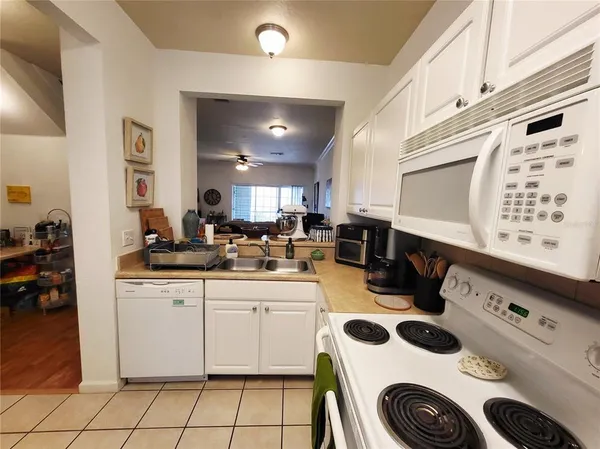 a kitchen with a sink a stove and cabinets