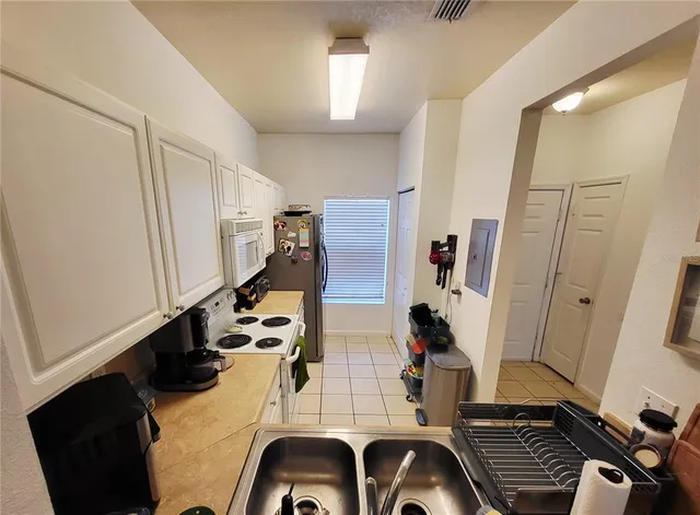 a view of living room with furniture and wooden floor