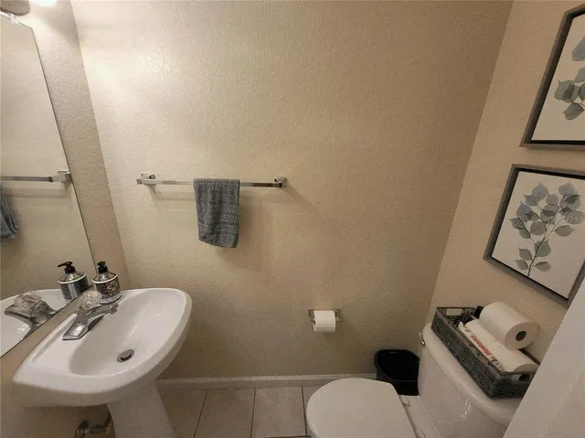 a bathroom with a sink mirror and toilet